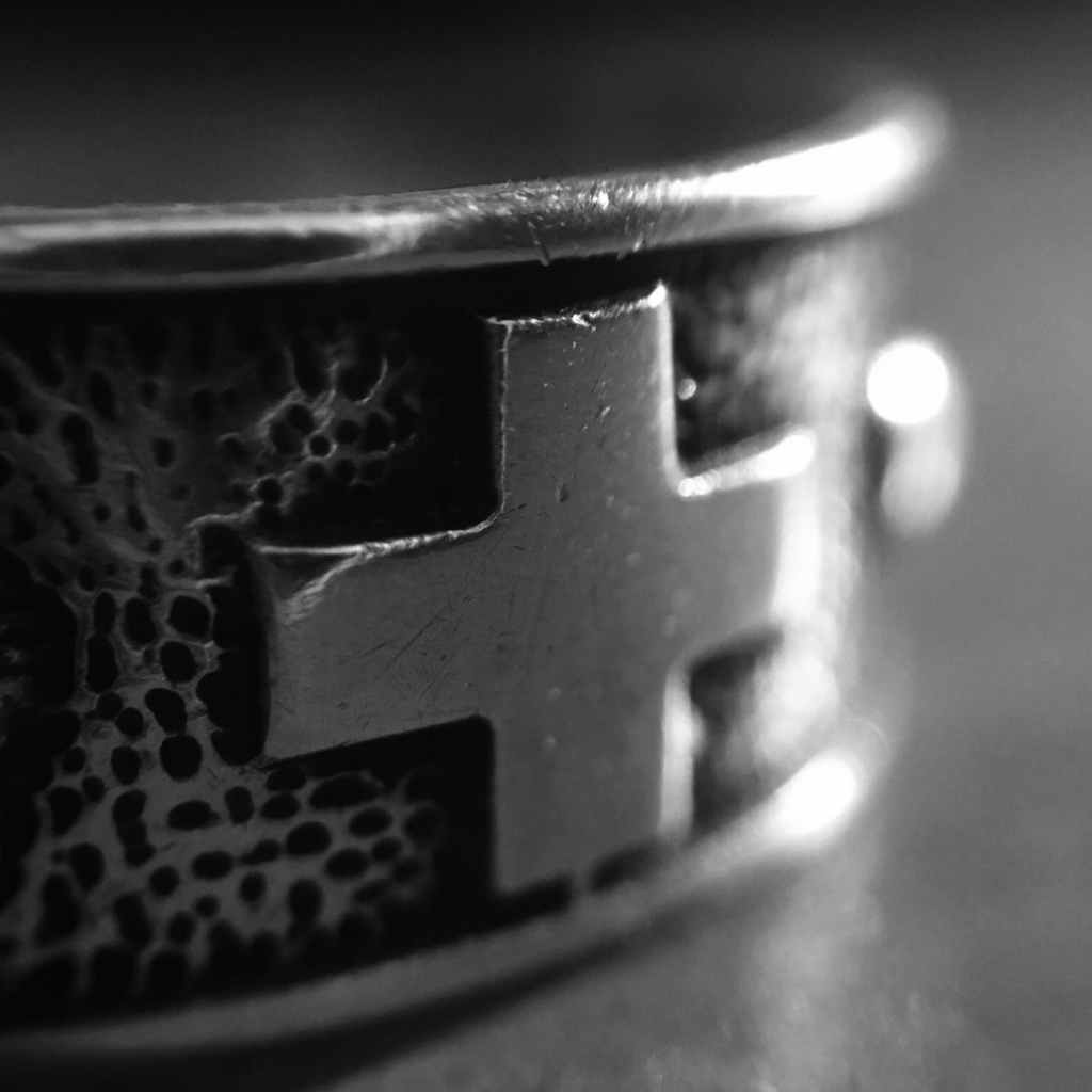 black and gray cross ring